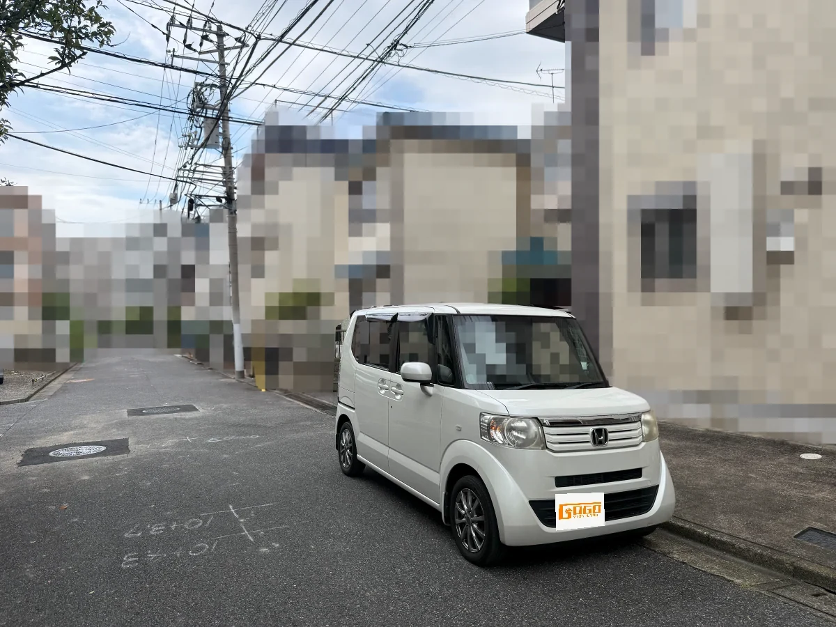 足立区梅島のお客様に実際にご利用いただいた白いホンダ N-BOX。ナンバーと住宅などの背景は個人情報保護のため隠しています